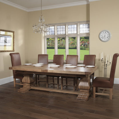 Carlton Furniture Windermere Rustic Monastery Extending Dining Table in Natural Oak features a solid thick table top, with chunky pedestal legs. The table can seat 8-10 when closed or 12-14 plus when fully extended