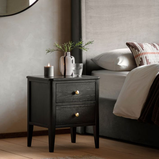 Gallery Direct Acton Black Bedside Cabinet features 2 Drawers with round gold coloured handles, a wood grain finish and slim tapered legs 