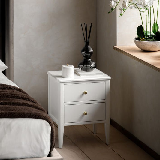 Gallery Direct Acton Bedside Table in White features 2 drawers with round gold coloured handles. and slim tapered legs
