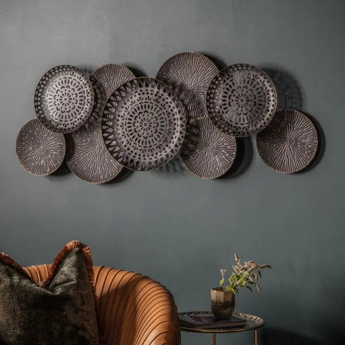 Gallery Direct Alga Metal Wall Art in a distressed bronze colour features nine sculptural plates that bring a contemporary feel to interior décor