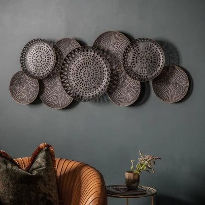 Gallery Direct Alga Metal Wall Art in a distressed bronze colour features nine sculptural plates that bring a contemporary feel to interior décor