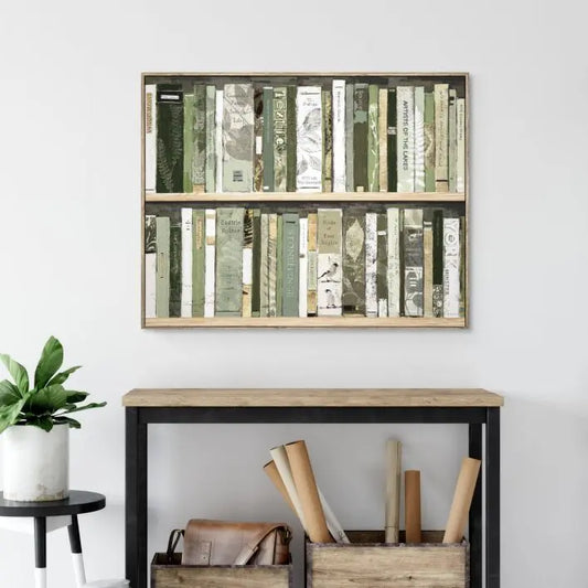 Gallery Direct Anthology Framed Canvas wall painting of bookcase shelves filled with books of outdoor exploration in a variety of calming greens surrounded by a natural oak wood frame