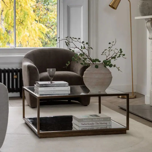 The Gallery Direct Avento Coffee Table has a contemporary industrial design, made from a bronzed metal frame with glass table top and a mirrored lower shelf