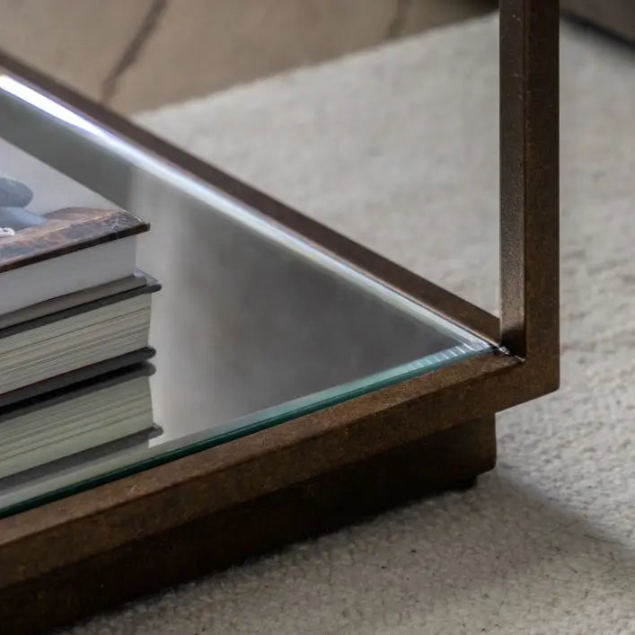 Gallery Direct Avento Side Table has a bronze colo9ured metal frame and a glass bottom shelf for additional storage
