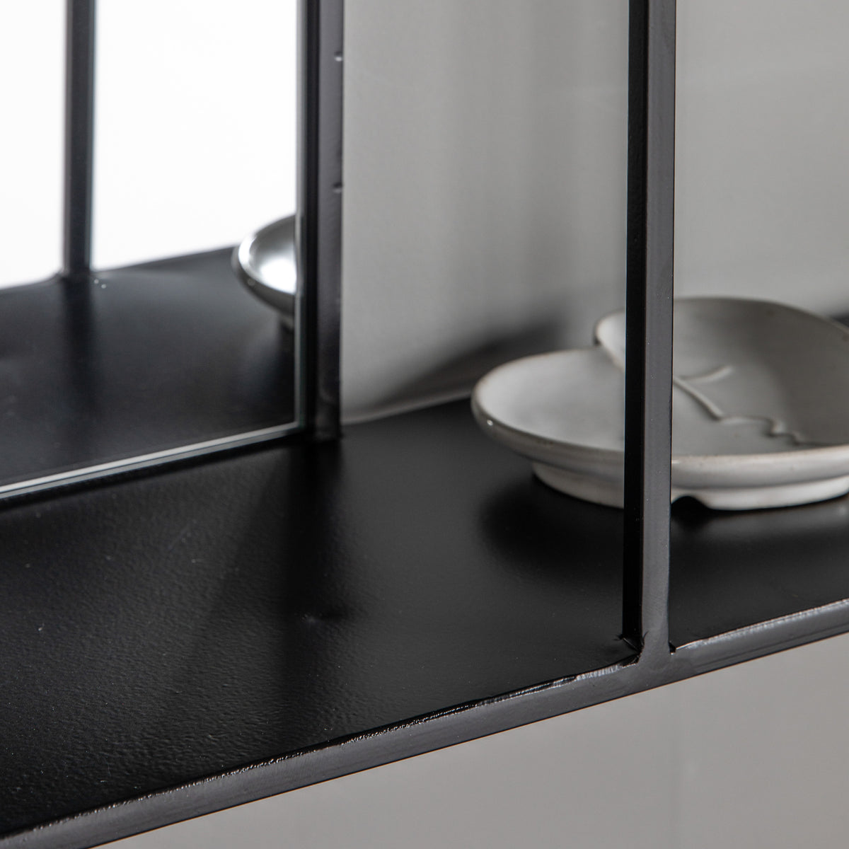 Gallery Direct Bassan Mirror Shelf Black, close-up of the mirror and frame details