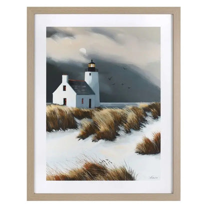 Gallery Direct Beyond the Dunes Framed Art by artist Sabrina Rosco features a serene coastal landscape with lighthouse and dunes with an oak effect frame
