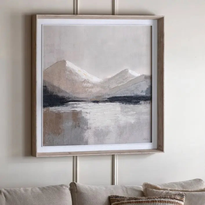Gallery Direct Beyond the Pale Framed Canvas features a mountain wilderness in tranquil tones and is framed with in a light neutral wood, by artist Sabrina Roscino