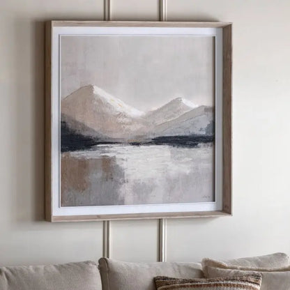 Gallery Direct Beyond the Pale Framed Canvas features a mountain wilderness in tranquil tones and is framed with in a light neutral wood, by artist Sabrina Roscino
