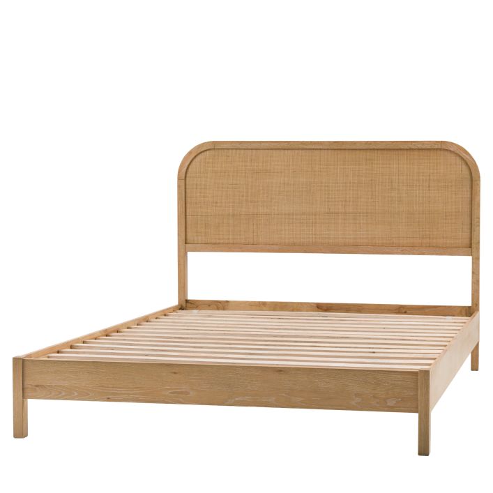 Gallery Direct Bibury Double Bed features a rattan headboard and lime washed finished frame, with wooden slats
