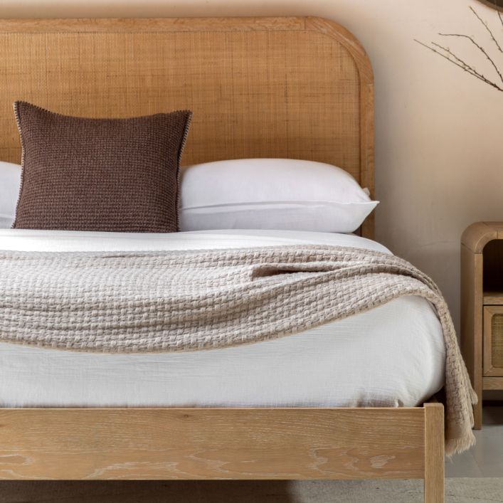 Gallery Direct Bibury King Size Bed with a curved rattan headboard and soft lime wash finished frame