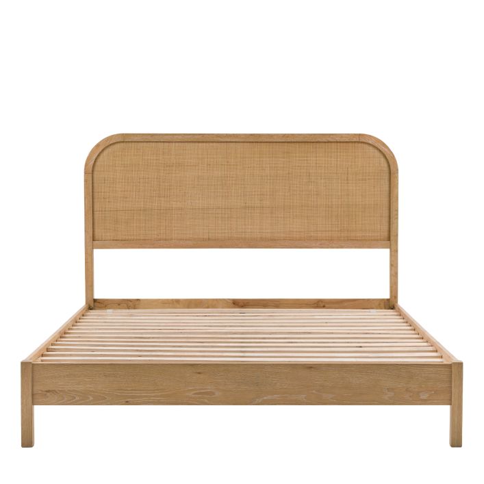 Gallery Direct Bibury King Size Bed has a oak and pine wood and veneer frame with a soft lime washed finish, wooden slats and a rattan detail headboard