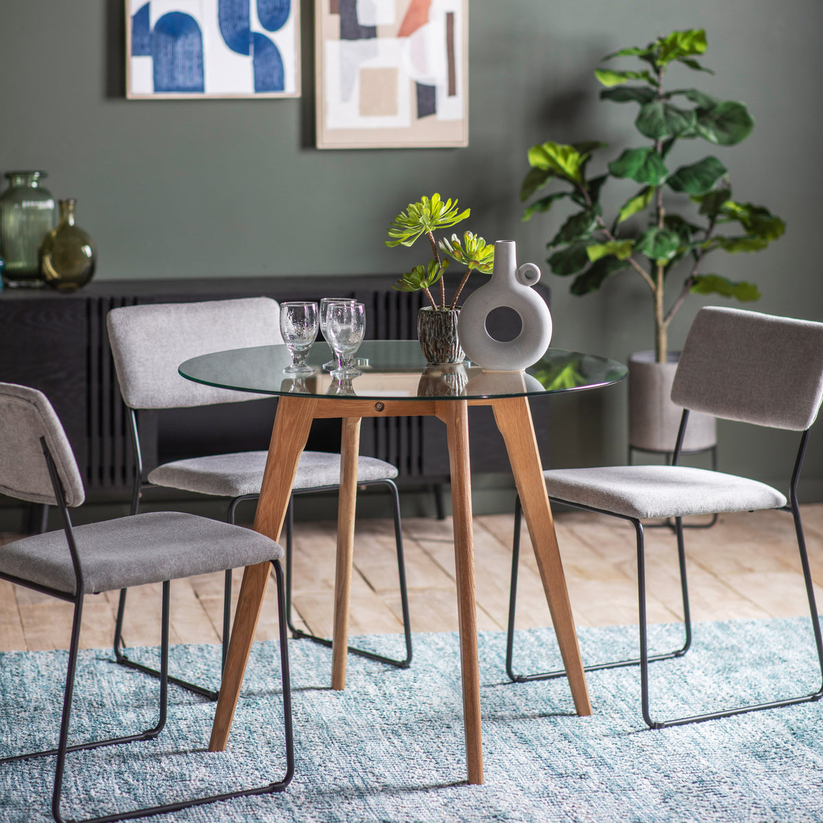 Gallery Direct Blair Round Dining Table Oak styled with chairs in a dining room