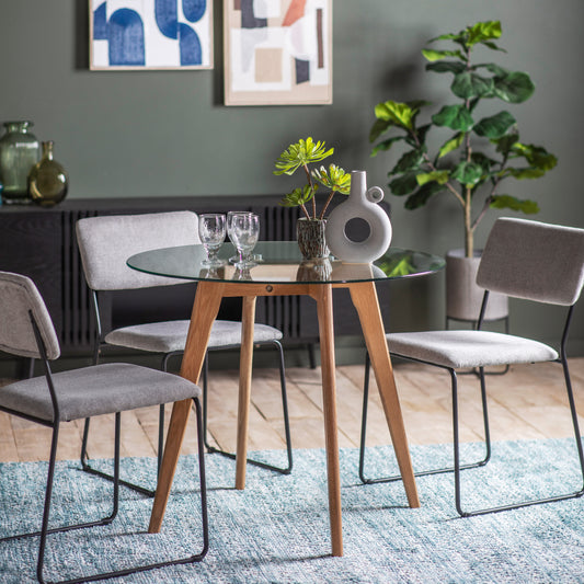 Gallery Direct Blair Round Dining Table Oak styled with chairs in a dining room