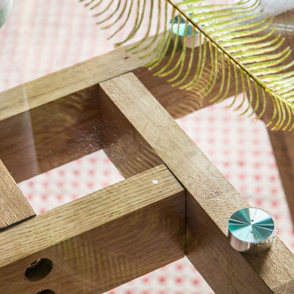 Close-up of the Blair dining table glass top and oak base