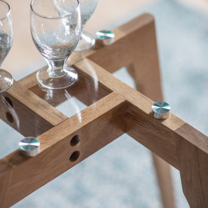 Detail of the Gallery Direct Blair oak dining table base beneath its glass top