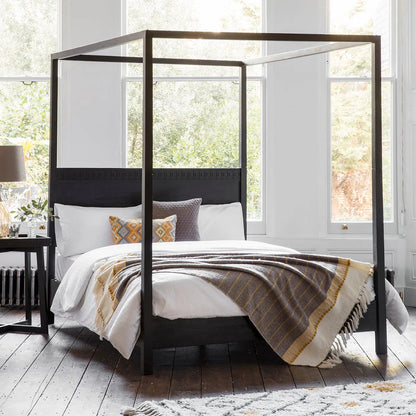 Gallery Direct Boho Boutique 4 Poster 6ft Super King Bed features an ethnic inspired inlaid pattern across the headboard, with a stunning matt black charcoal finish 