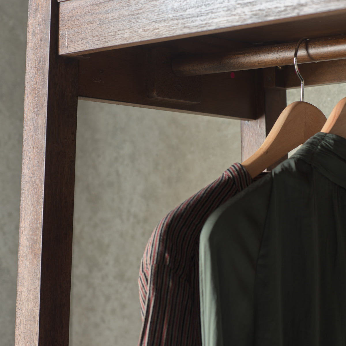 Close-up of the Boho Retreat wardrobe timber rail and hanging space