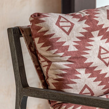 Gallery Direct Burela Lounge Chair is upholstered in a red and natural colour padded fabric, with a Mira Aztec pattern and a dark wooden frame