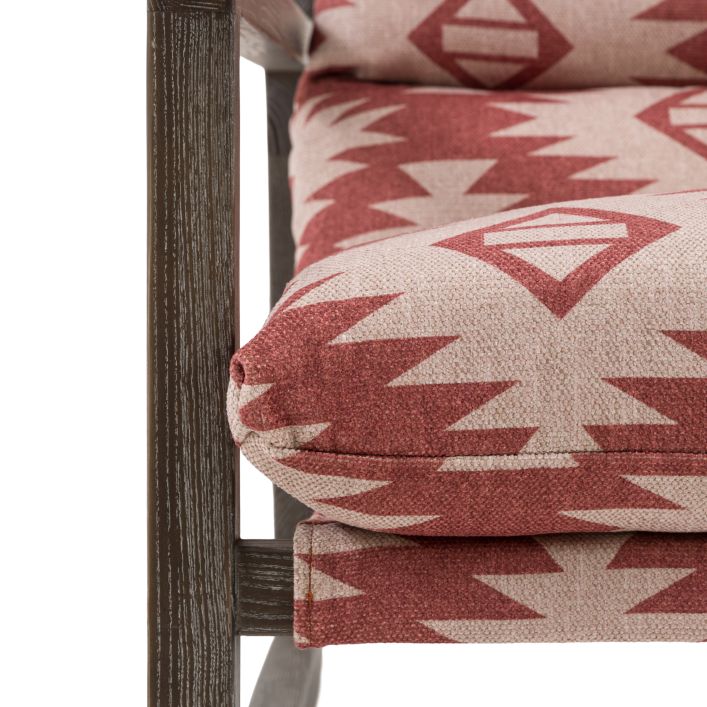 Gallery Direct Burela Lounge Chair upholstered in red/neutral colour Mira Aztec patterned fabric, with a dark wooden frame 