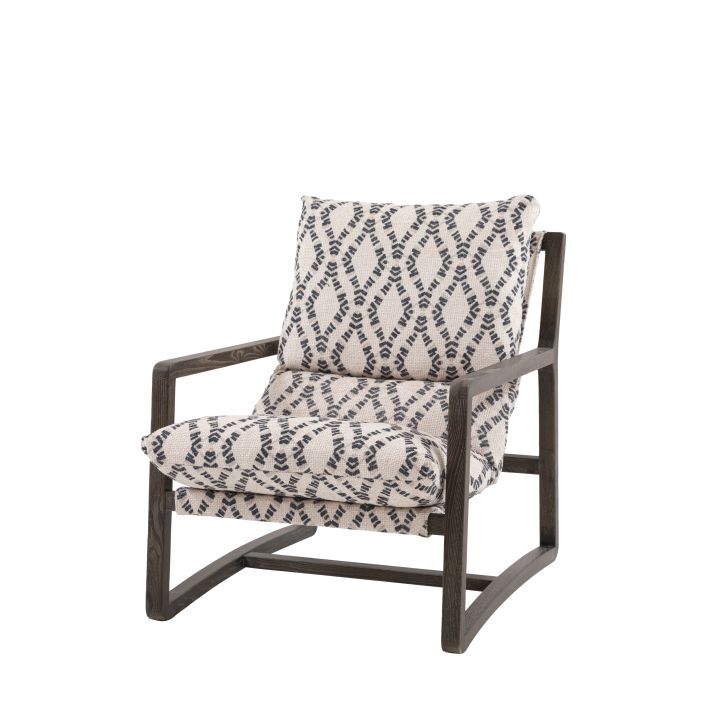 The Gallery Direct Burela Lounge Chair is upholstered in Obi Diamond patterned fabric with a dark wooden frame