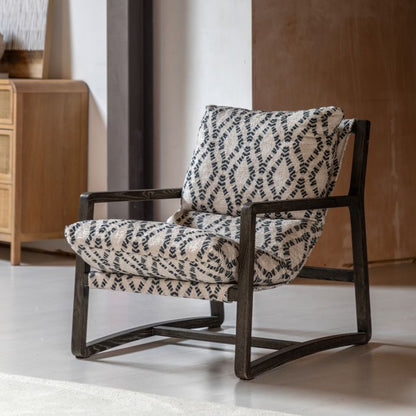 The Gallery Direct Burela Chair is a comfortable padded lounge seat in navy/natural coloured Obi Diamond pattern, with a rich dark ash wood frame