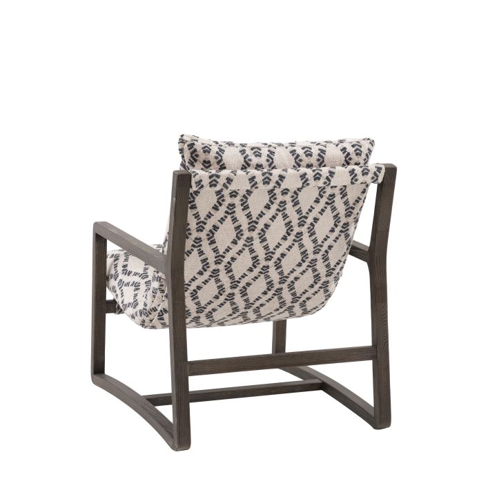 The Gallery Direct Burela Lounge Chair in Obi Diamond patterned upholstery with a rich dark wooden frame
