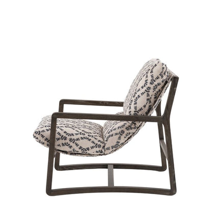 Gallery Direct Burela Lounge Chair in Obi Diamond patterned upholstery, with a rich dark wooden frame