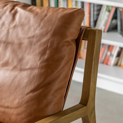 Gallery Direct Burela Lounge Chair in Vintage Brown Leather with padded seat and backrest for additional comfort, and a solid ash wood contemporary frame
