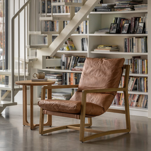 The Gallery Direct Burela Lounge Chair is upholstered in Vintage Brown padded Leather with a sturdy ash wood frame