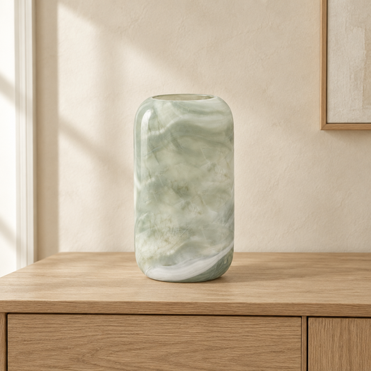 Gallery Direct Caldeira Handblown Glass Vase Slim Sage displayed on an oak console in a softly lit neutral interior