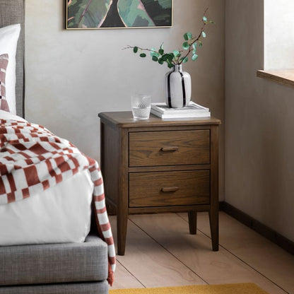 Gallery Direct Camden 2 Drawer Bedside Cabinet in a dark Walnut wood-grain finish with matching handles and slim tapered legs