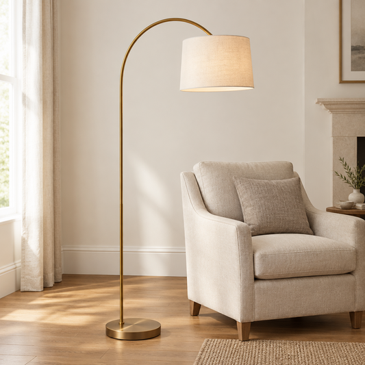 Gallery Direct Carlson Floor Lamp Warm Brass styled beside a linen armchair