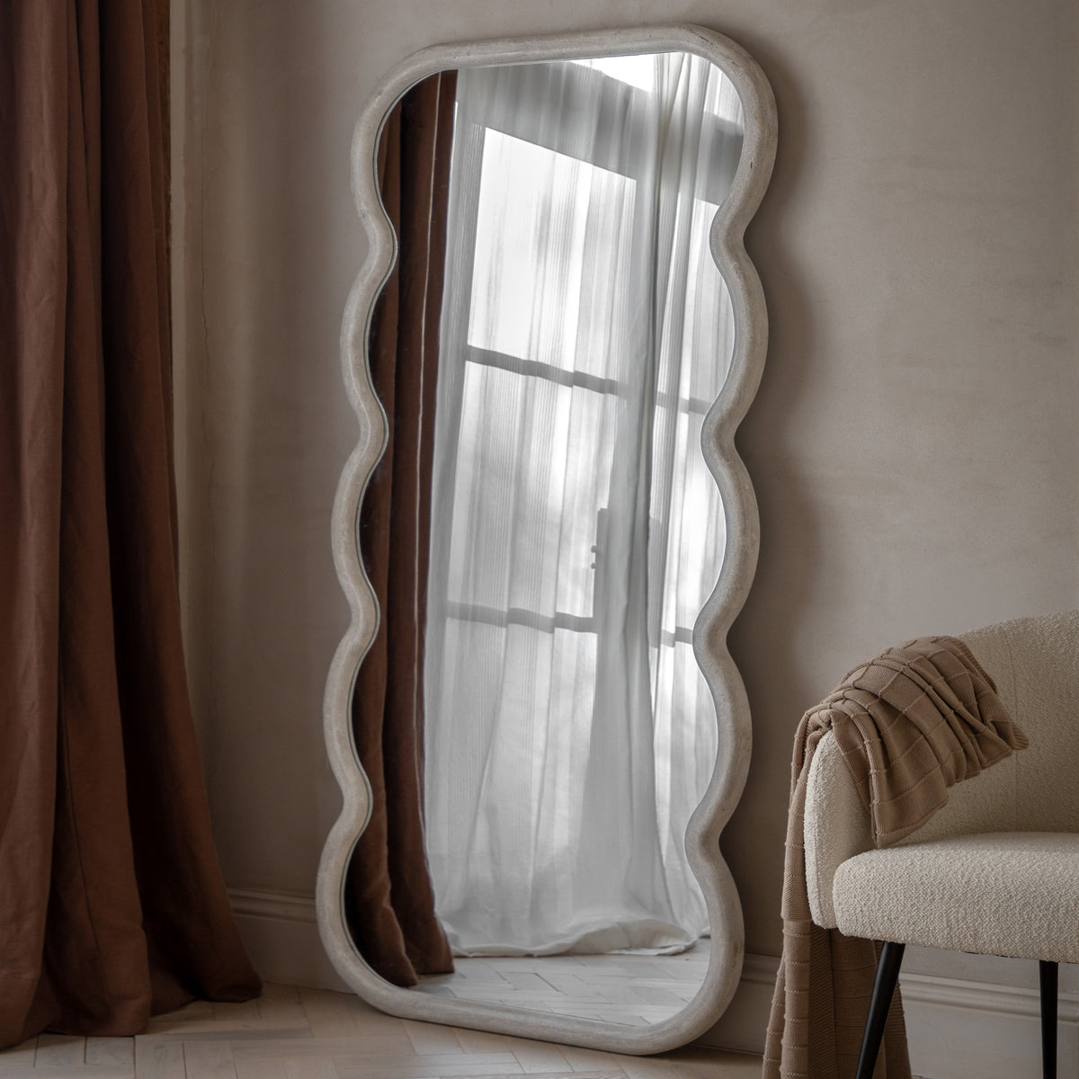 Gallery Direct Como Curved Leaner Mirror displayed in a styled interior
