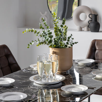Gallery Direct Davidson dining table styled with tableware on its black marble effect top