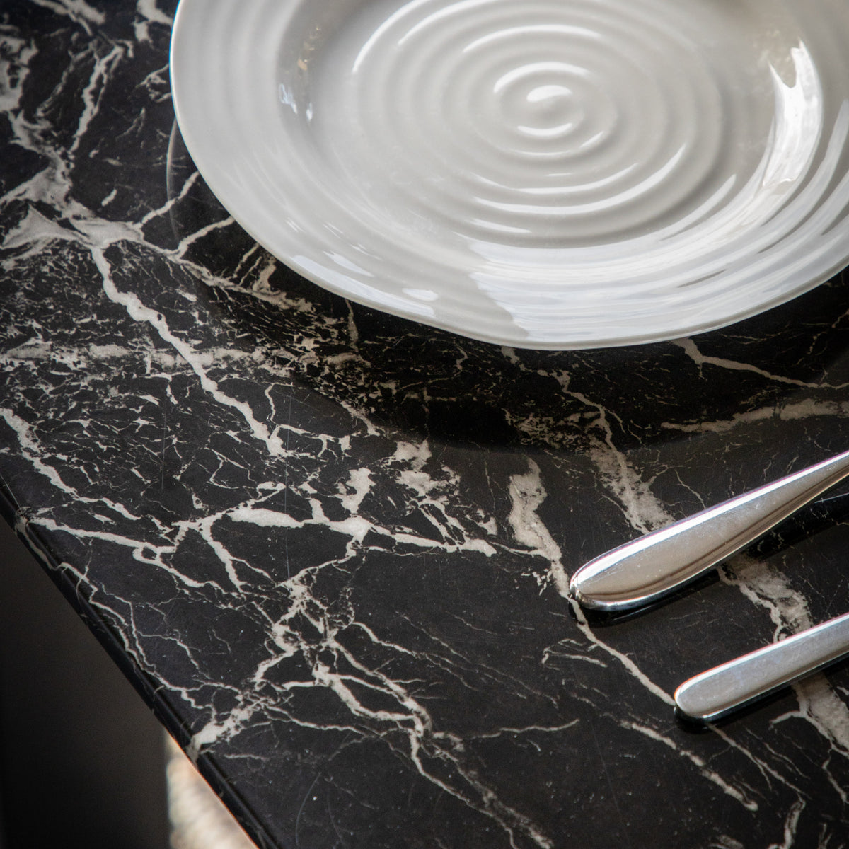 Close-up of the Davidson table black marble effect glass top