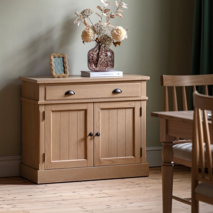 Gallery Direct Eton Sideboard in natural oak and veneers, features 2 cupboard doors with grooved panelling, and 1 top drawer, with metal handles