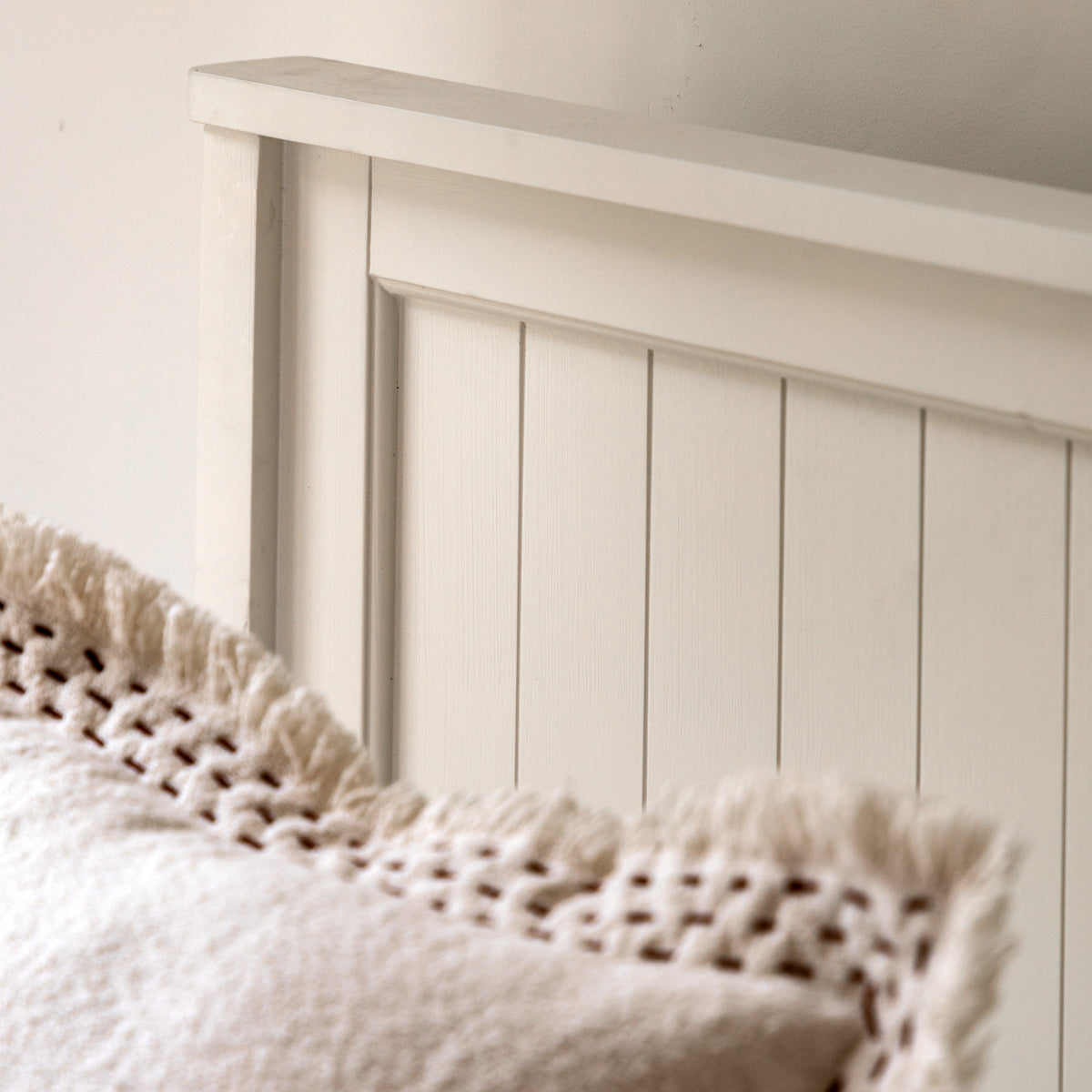 Close-up of the Eton white bed panelled headboard in a bedroom