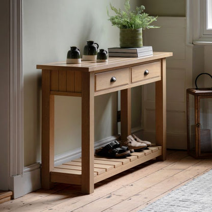Gallery Direct Eton 2 Drawer Console Table in a Natural Oak effect wooden frame with metal handles and a planked lower shelf 