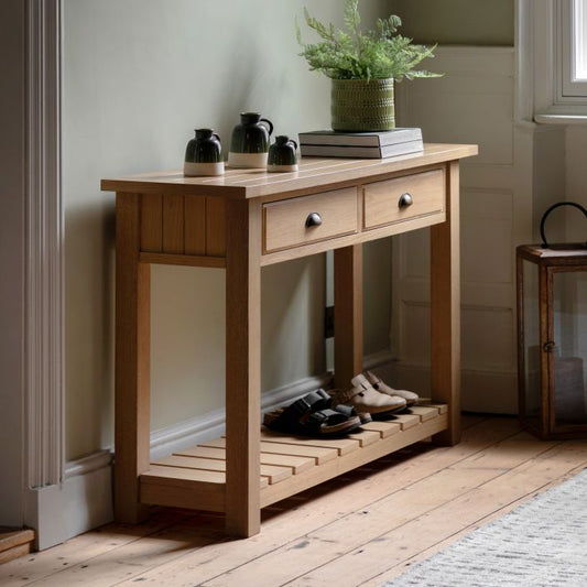 Gallery Direct Eton 2 Drawer Console Table in a Natural Oak effect wooden frame with metal handles and a planked lower shelf 