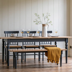Gallery Direct Eton Dining Table in Meteor can extend to seat 8-10 people, with an oak wood grooved top and painted spindle legs