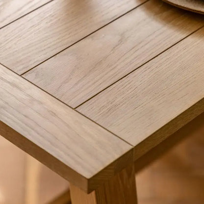 Gallery Direct Eton Extending Trestle Dining Table in Natural features a grooved and planked table top
