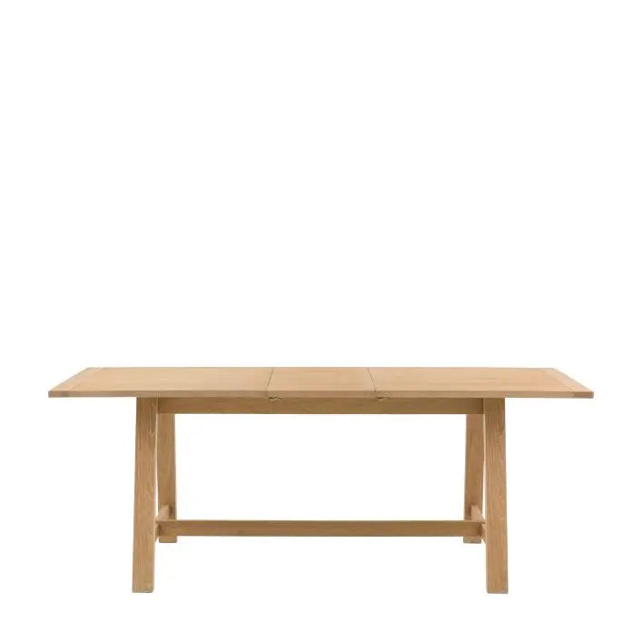 Gallery Direct Eton Extending Trestle Dining Table in Natural oak finish with a grooved planked table top and trestle style legs