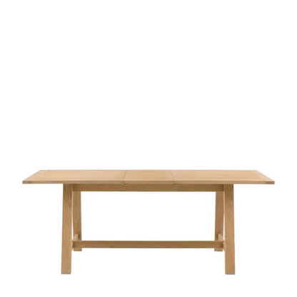 Gallery Direct Eton Extending Trestle Dining Table in Natural oak finish with a grooved planked table top and trestle style legs
