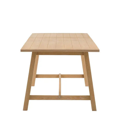 Gallery Direct Eton Extending Dining Table with a grooved and planked table top and trestle style legs in Natural
