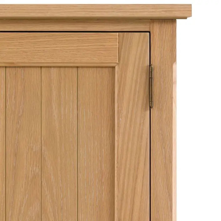 Gallery Direct Eton Larder Cupboard features grooved panel doors in a natural oak wood finish