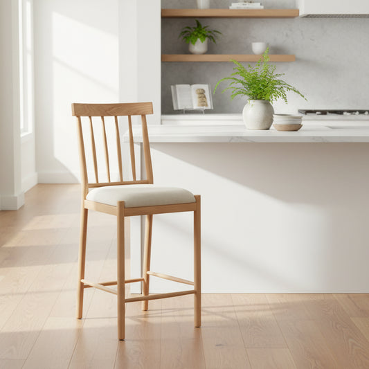 Gallery Direct Eton Pair of Bar Stools upholstered in a Natural coloured fabric, with an oak wood finished frame, spindle backrest and lower foot bar
