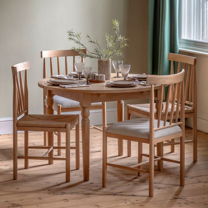 Gallery Direct Eton Round Extending Dining Table in Natural oak wood and veneers, features grooved table top, turned wooden legs and removable leaf extension, can seat 4-6 people