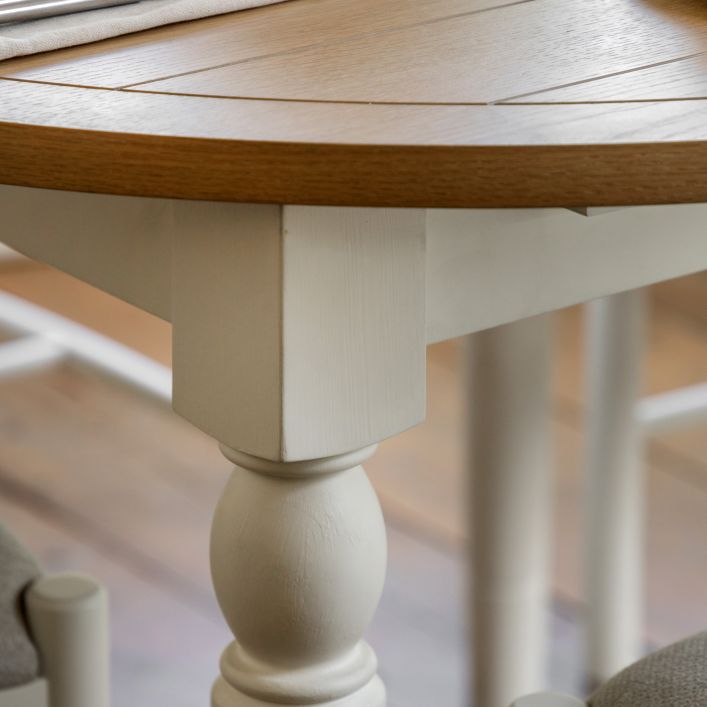 Gallery Direct Eton Round Extending Dining Table features white painted legs and an oak wood and veneer table top