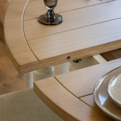 Gallery Direct Eton Round Extending Dining Table in White features an oak wood and veneer grooved table top that extends to seat 4-6 people