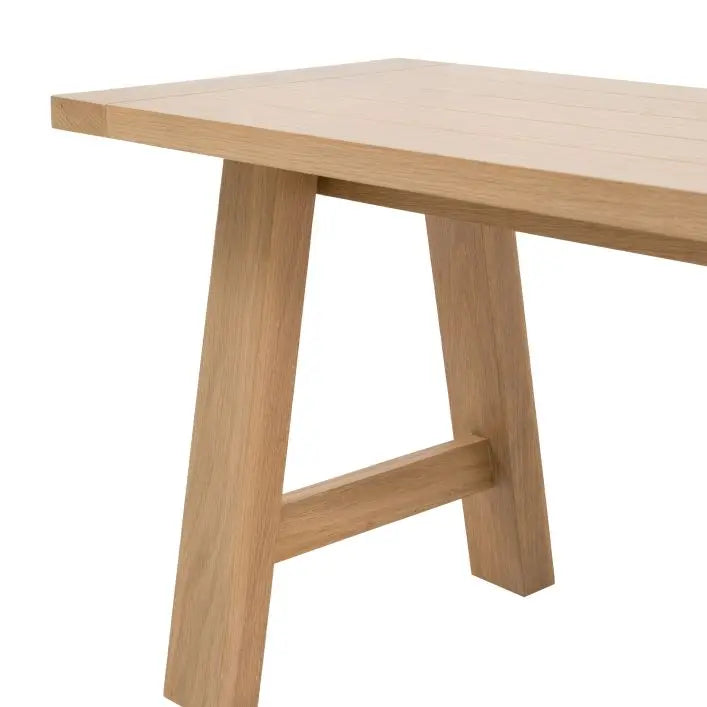 Gallery Direct Eton Trestle Bench in a Natural oak wood with angled timber underframe